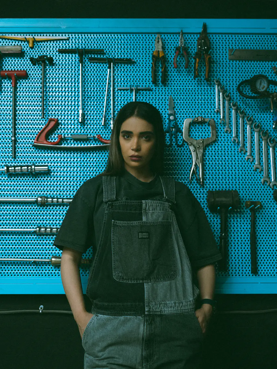 Erin Halloran standing in front of a pegboard of tools